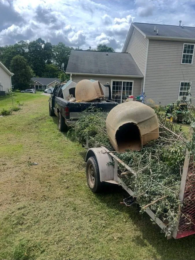A concrete tank and brush loaded on our trailer