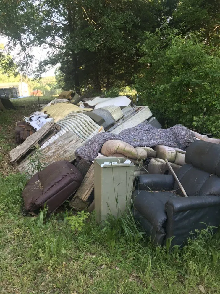 A pile of furniture and mattresses waiting for pickup