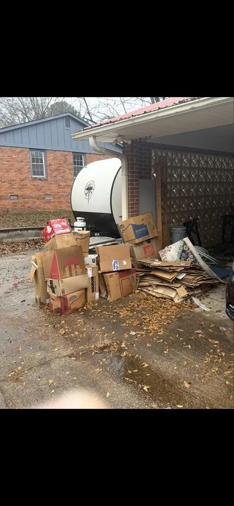 Boxes and debris stacked outside a garage